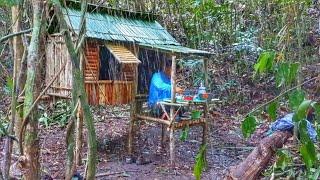 solo camping heavy rain while building a simple shelter in the middle of the forest.