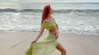 Dancing with the Waves: A Sensual Beach Escape in a Sheer Green Dress