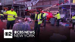 Cleaning up Times Square after New Year's Eve ball drop in NYC