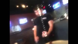 Native Waiter sings danger zone and does air guitar for cus