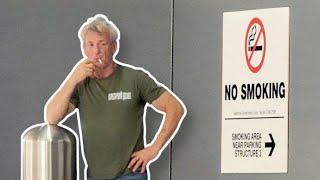 Sean Penn Smokes In Prohibited Area As Airport Employee Keeps A Lookout