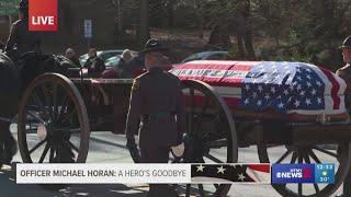 Horse-drawn caisson carries Officer Michael Horan to funeral service