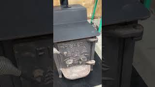 Just installed new wood stove in garage . Fisher Papa Bear.      #logging #chainsaw #woodstove