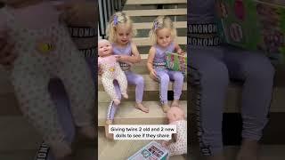 Twin sisters sharing baby dolls. Cutest video