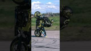 Stunt riding wheelie on the handlebar - scratching the ground