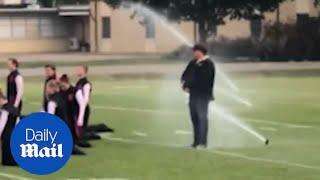 Selfless band director shields students from sprinkler