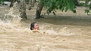 Due to heavy flood  a girl was taken away by flood while riding bike  in tumpreng reserve forest.