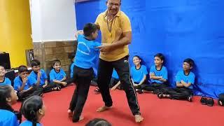 Watch as our dedicated teacher empowers students with essential self-defense skills! 