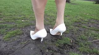 Ugh! My high heels keep getting stuck! White stiletto shoes sinking in soft grass and mud . . .