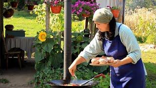 Cooking a rustic dinner over a campfire. Simple life of a family in a remote village