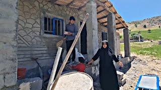 Painting the door and windows of the house by a nomadic man