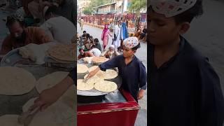 Making bread hard work 10 year old Afghan boy for breakfast in Afghanistan