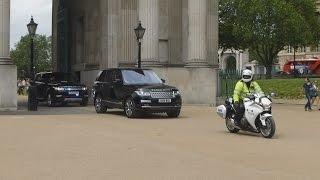 Metropolitan Police Special Escort Group escorting horse carriages and car in London