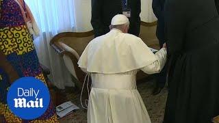 Pope Francis kneels to kiss feet of South Sudan rival leaders