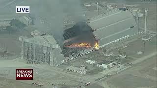 Massive fire burns through historic hangar in California