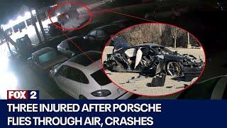 Three injured after Porsche flies through air, crashes