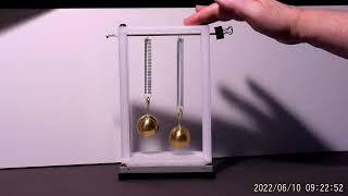 BOUNCING BRASS BALLS: Micro-gravity between two objects revealed.