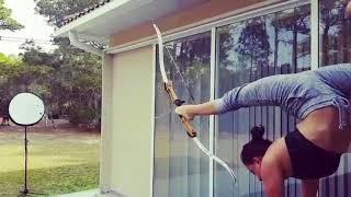 Woman Shoots Bow With Feet While Performing Handstand - 985714