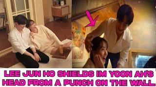 Lee Jun Ho shields Im Yoon Ah's head from a punch on the wall.