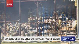 CCFD continue containment efforts for large warehouse fire off Lipan St.