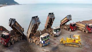 Filling Up Rock Pouring Into The Sea Almost With Dump truck TRAGO Transport Stone And Dozer KOMATSU