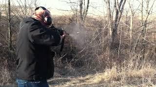 Cutting down a tree with a prototype selective fire ArmaLite AR-10 A4 carbine