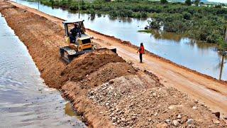 Wonderful repairing road construction Technology by komatsu dozer with dump truck unloading soil.