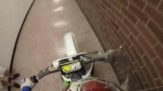 Riding dirt bike through school