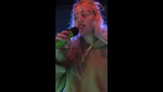 Billie Eilish gives water to a fan who's about to pass out during Ocean Eyes