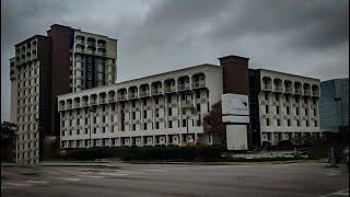 Exploring THE MOST DANGEROUS abandoned hotel in Dallas [HELD AT GUNPOINT!]