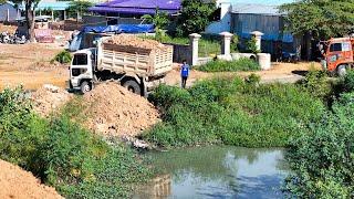 Impressive work! bulldozer and dump trucks filling land over water with pretty skills technique