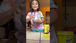 Bella making chocolate milk 2021