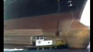 Ship drops anchor on tug boat.