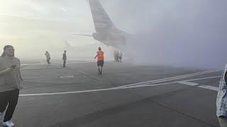 Raw: Passengers run from plane on Denver runway