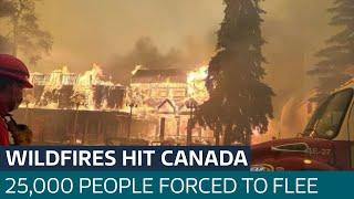 Fast moving wildfires force 25,000 to evacuate historic Canadian town | ITV News