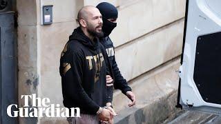 Handcuffed Tate brothers leave court after hearing