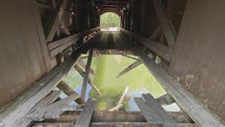 'This is a first': Dump truck falls through covered bridge in Gorham