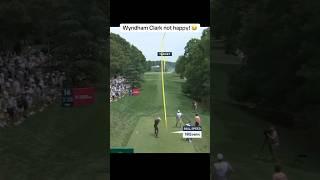 Wyndham Clark throws his club after driving into the bunker