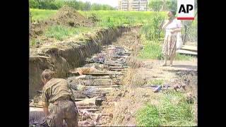 Chechnya - Cleanup In Grozny Reveals Grim Harvest