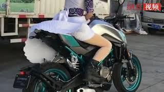 biker girl in a skirt takes off on sports bike