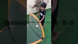 Adam plays football in the backyard with mahad