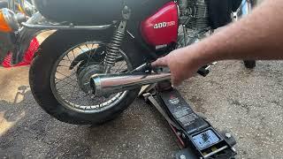 How tosafely jack up motorcycle rear wheel with only a side stand .