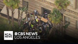 Protesters barricade near Moore Hall on UCLA campus as police surround area