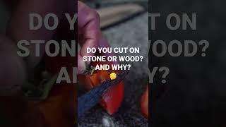 I cut on stone despite dulling faster because the wood can swell, mold, and retain bacteria.