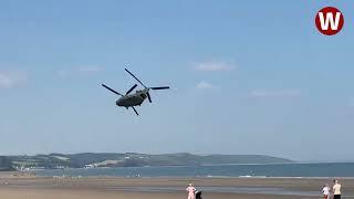 Moment low-flying Chinook helicopter thunders over Welsh beach