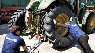 Process of turning old tractor tire into new tire. Korean skilled mechanic