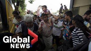 Migrants break through fence at Guatemala-Mexico border