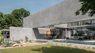 A Concrete Home With Beautiful View Of Pool And Garden