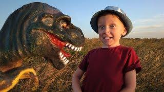 Leo has fun walking with a Dinosaur in the Park