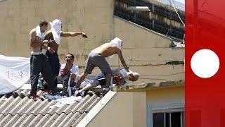 Brazil inmates take over prison, threaten to throw 10 hostages off roof